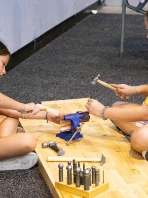 Two FutureFusion students fabricating metal at Atlanta Jewelry Show